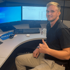 2024 Summer Intern Cooper Pennington Working at Desk